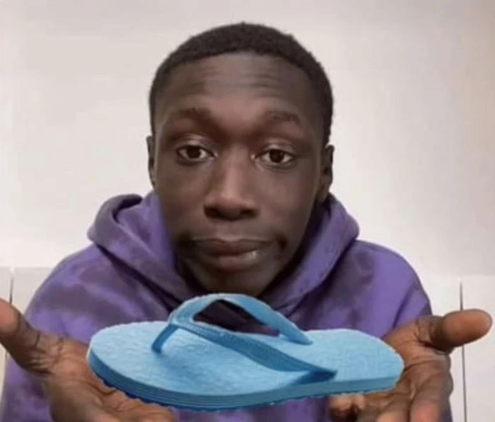 Black guy Khaby Lame holding blue sandal meme